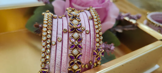 Elegant Pink Silk Thread Bangles Set with Gold-Plated Floral and Stonework Design